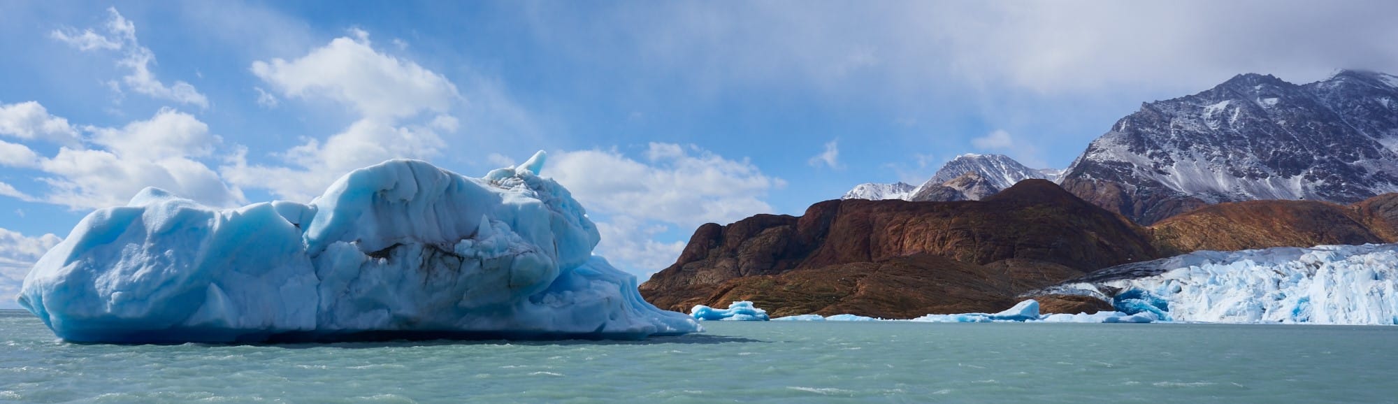 There is an iceberg, perhaps a reachable distance from land, The purpose of the image is to show that that's what alliances mean to PKP, that is, a forged, reliable relationship in constantly changing sometimes perilous environment.