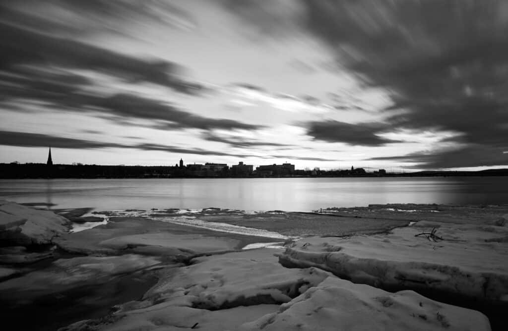The perspective makes it look like one is standing on a sheet of ice looking out over a vast body of water and a big open sky. The purpose of the image is to line up with the question, 