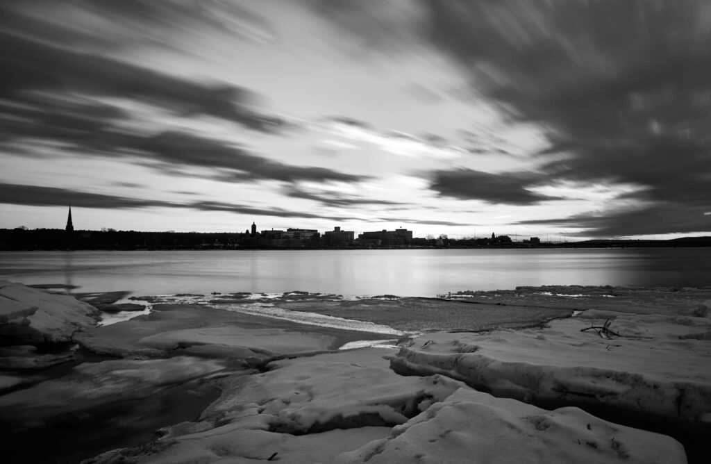 The perspective makes it look like one is standing on a sheet of ice looking out over a vast body of water and a big open sky. The purpose of the image is to line up with the question, 
